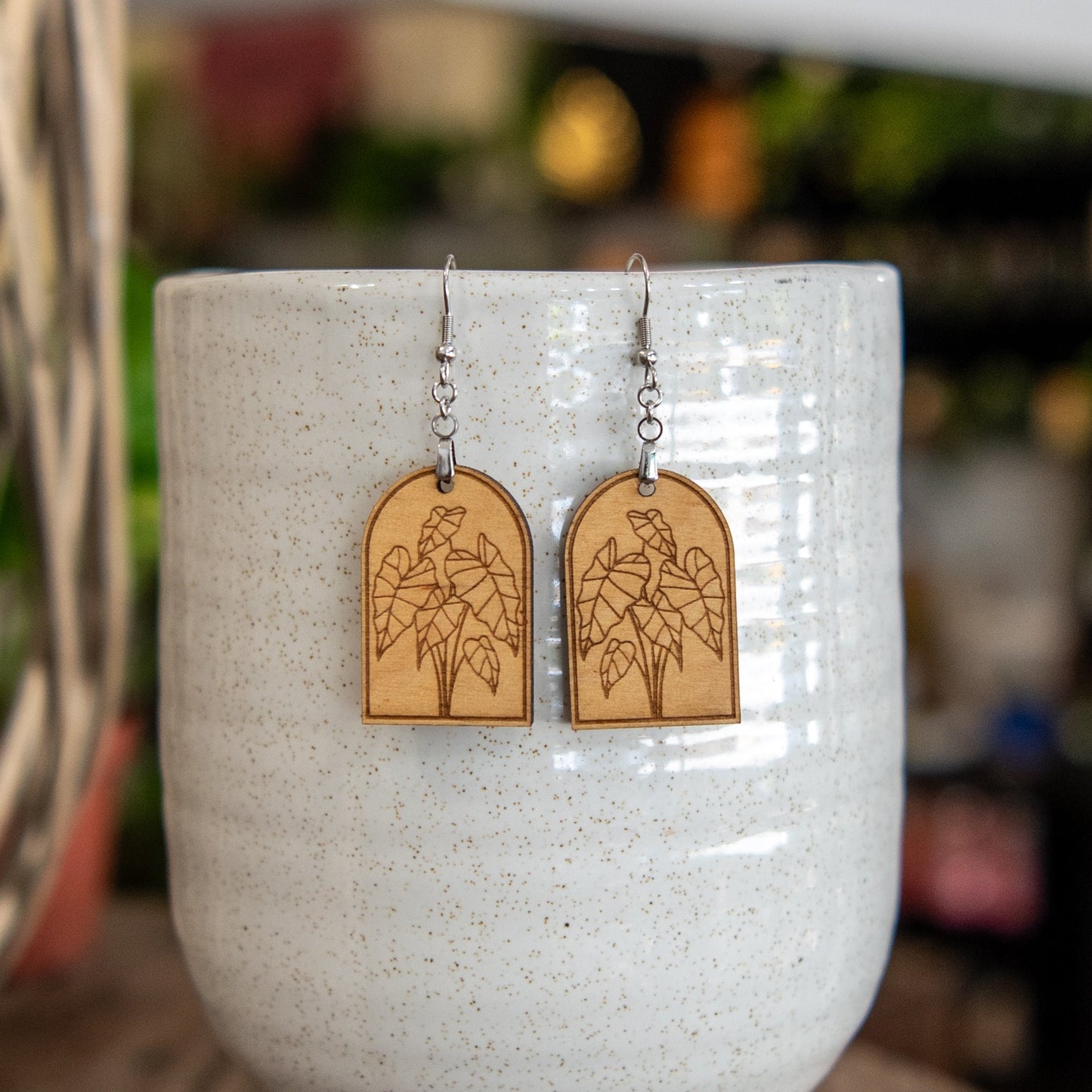 Still Magnolia Alocasia Arched Earrings featuring elegant, leaf-shaped design in silver with intricate detailing.