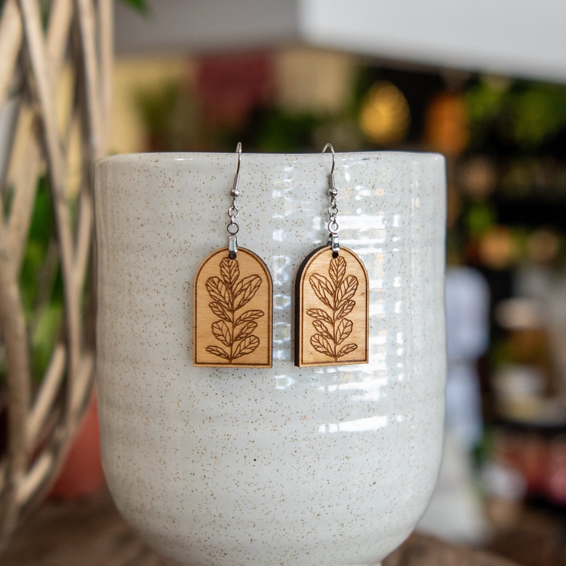 Still Magnolia Fiddle Leaf Fig Arched Earrings, gold-tone earrings with leaf-shaped design, stylish jewelry for women.