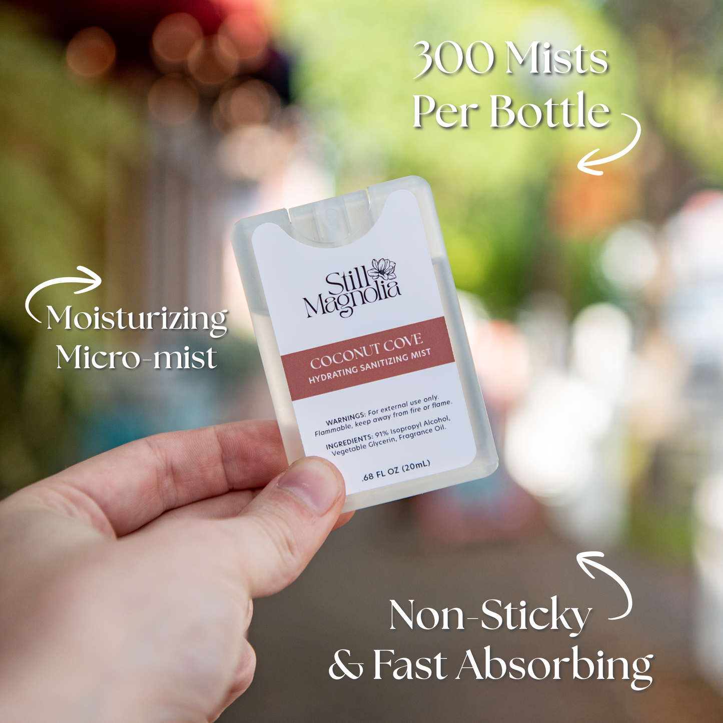 Still Magnolia Coconut Cove Hydrating Sanitizing Mist with coconut scent, featuring a spray bottle for on-the-go skin hydration and sanitization.