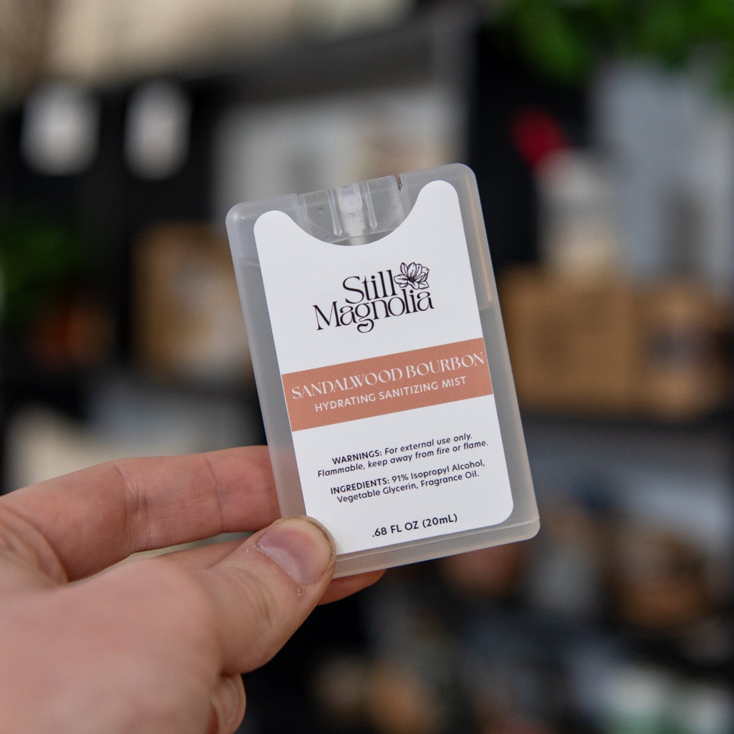 Still Magnolia Sandalwood Bourbon Hydrating Sanitizing Mist bottle with a sleek design and natural scent, perfect for on-the-go use.
