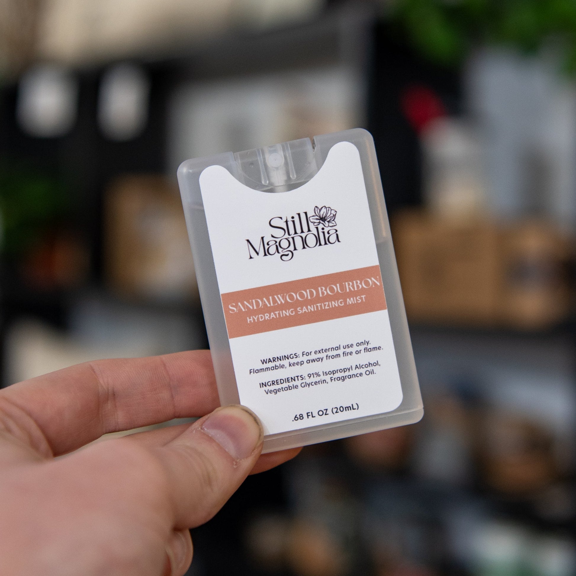 Still Magnolia Sandalwood Bourbon Hydrating Sanitizing Mist bottle with a sleek design and natural scent, perfect for on-the-go use.