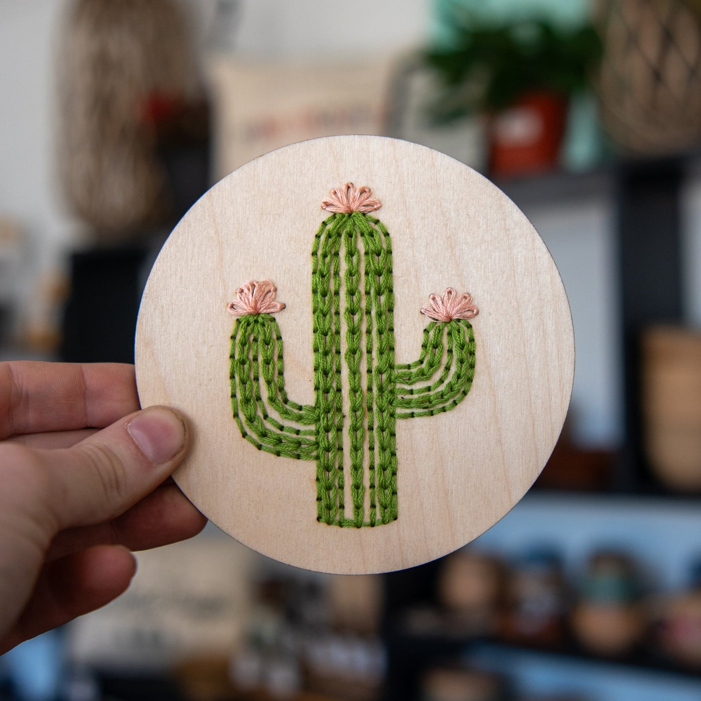 Still Magnolia cactus embroidery kit featuring colorful thread, fabric, and embroidery tools for creating a detailed cactus design.
