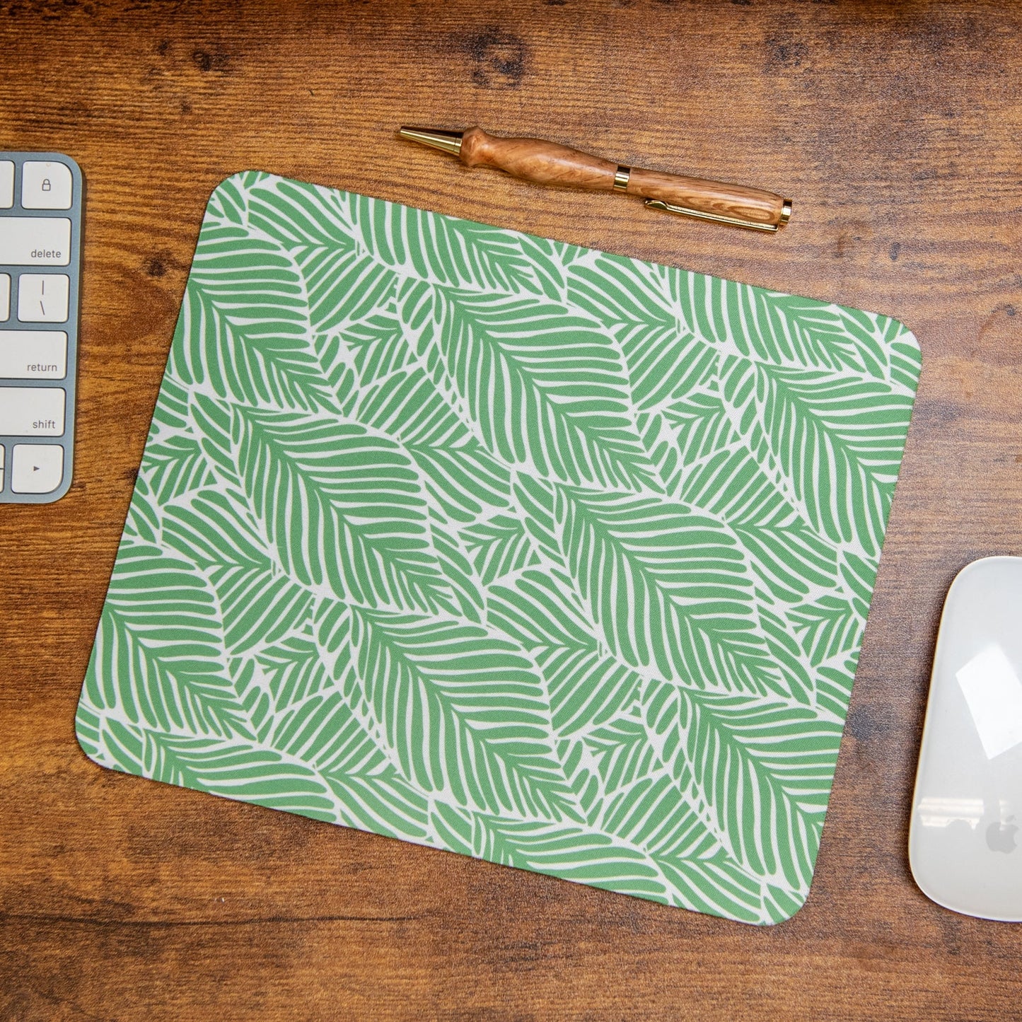 Still Magnolia Leafy Luxe mouse pad with vibrant green leafy design, providing a stylish and comfortable surface for computer use.