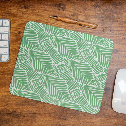 Still Magnolia Leafy Luxe mouse pad with vibrant green leafy design, providing a stylish and comfortable surface for computer use.