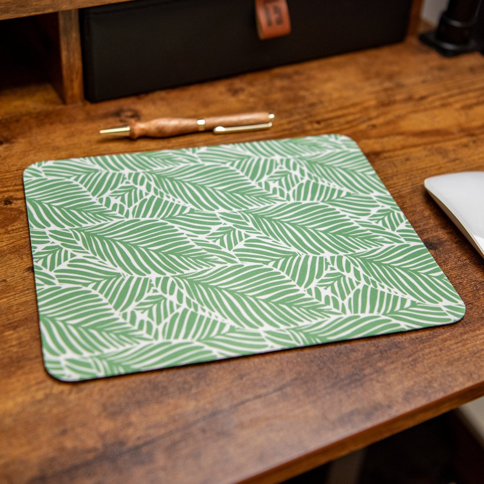Leafy Luxe Still Magnolia mouse pad featuring a vibrant leafy design on a smooth surface for comfortable use.