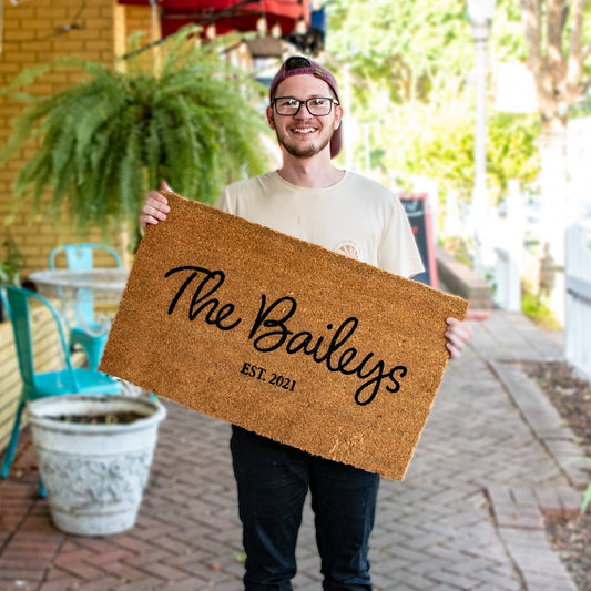 Personalized Still Magnolia family name doormat with custom text, featuring a welcoming design for home entrance.