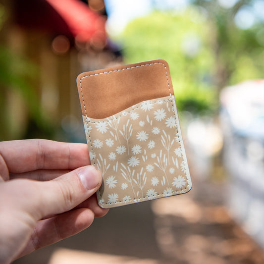 Still Magnolia Daisy Daydream pattern phone wallet with card slots, featuring vibrant floral design and compact, functional style.