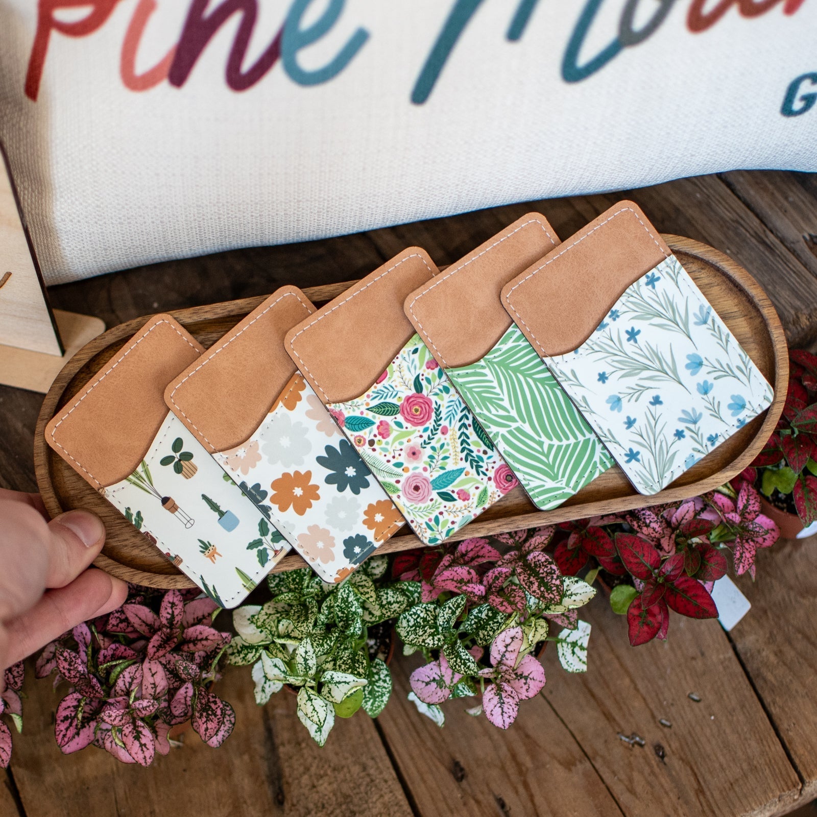 Still Magnolia Daisy Daydream pattern phone wallet with card slots, featuring a colorful floral design on a soft fabric background.