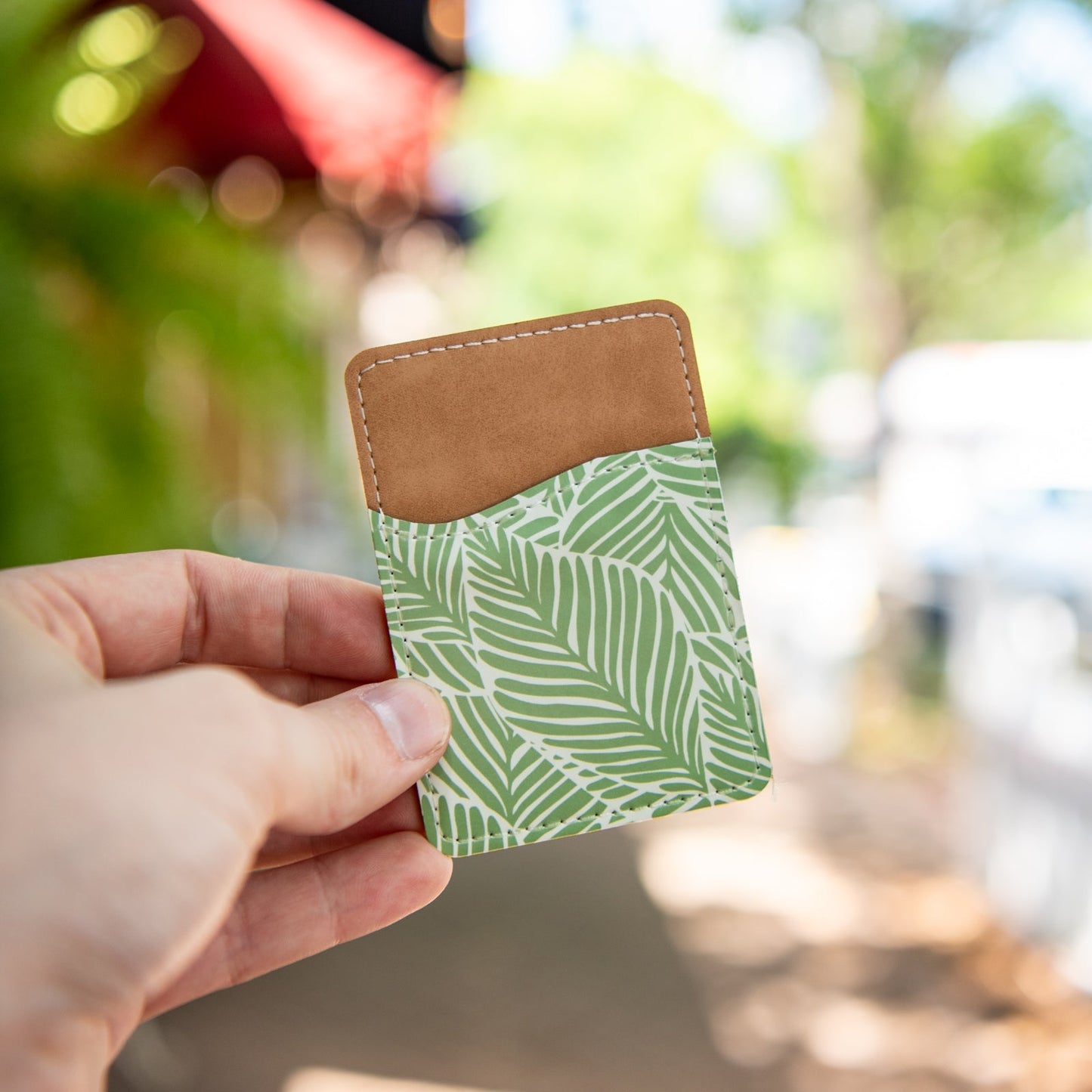 Still Magnolia Leafy Luxe phone wallet with leaf pattern, slim design, and multiple card slots for convenience.