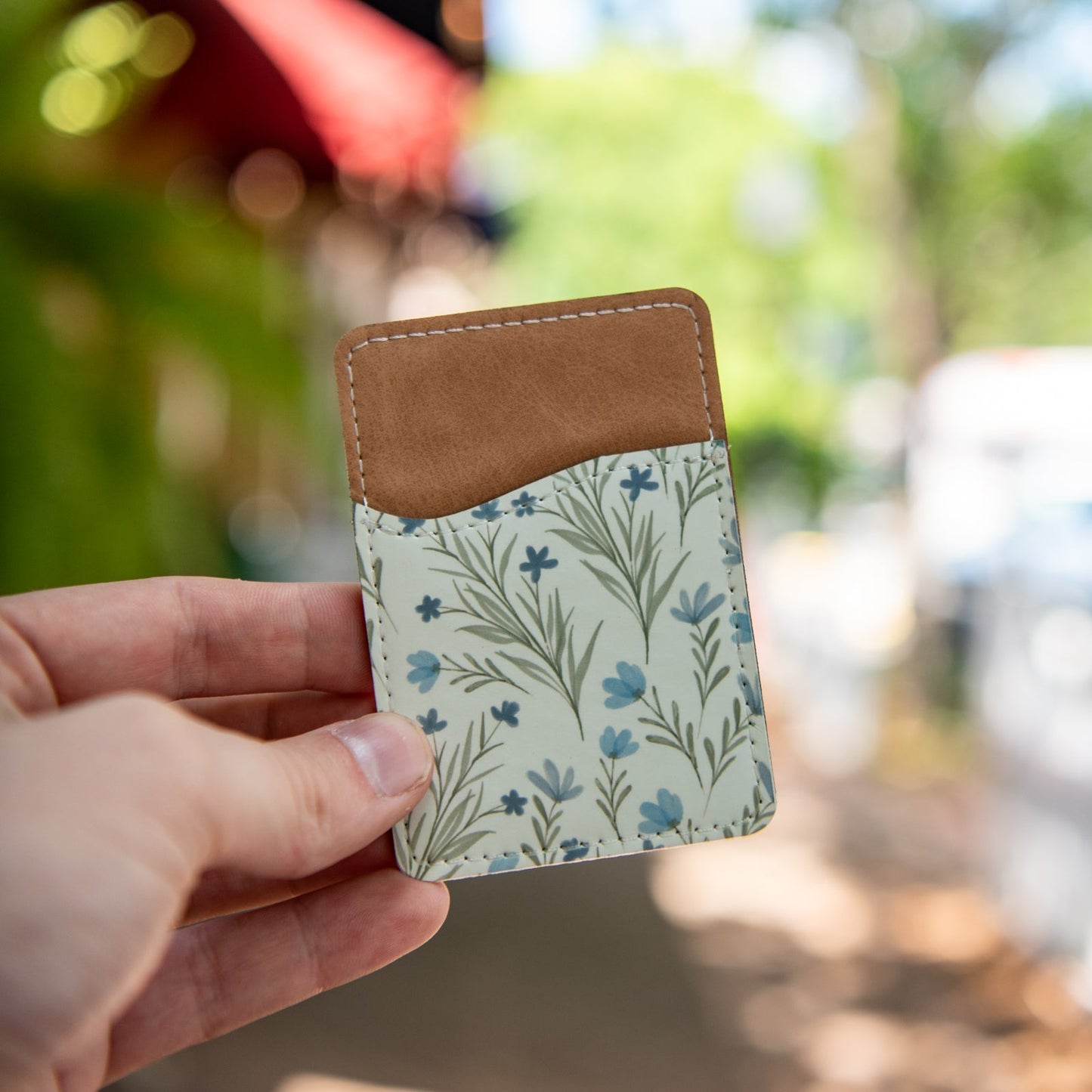Still Magnolia Wildflower Whisper pattern phone wallet with card slots and floral design on soft material.