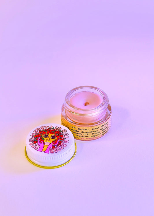 Plant Makeup Strawberry Dreamsicle Lip Balm Scrub featuring a jar of pink and white scrub with fresh strawberry accents.