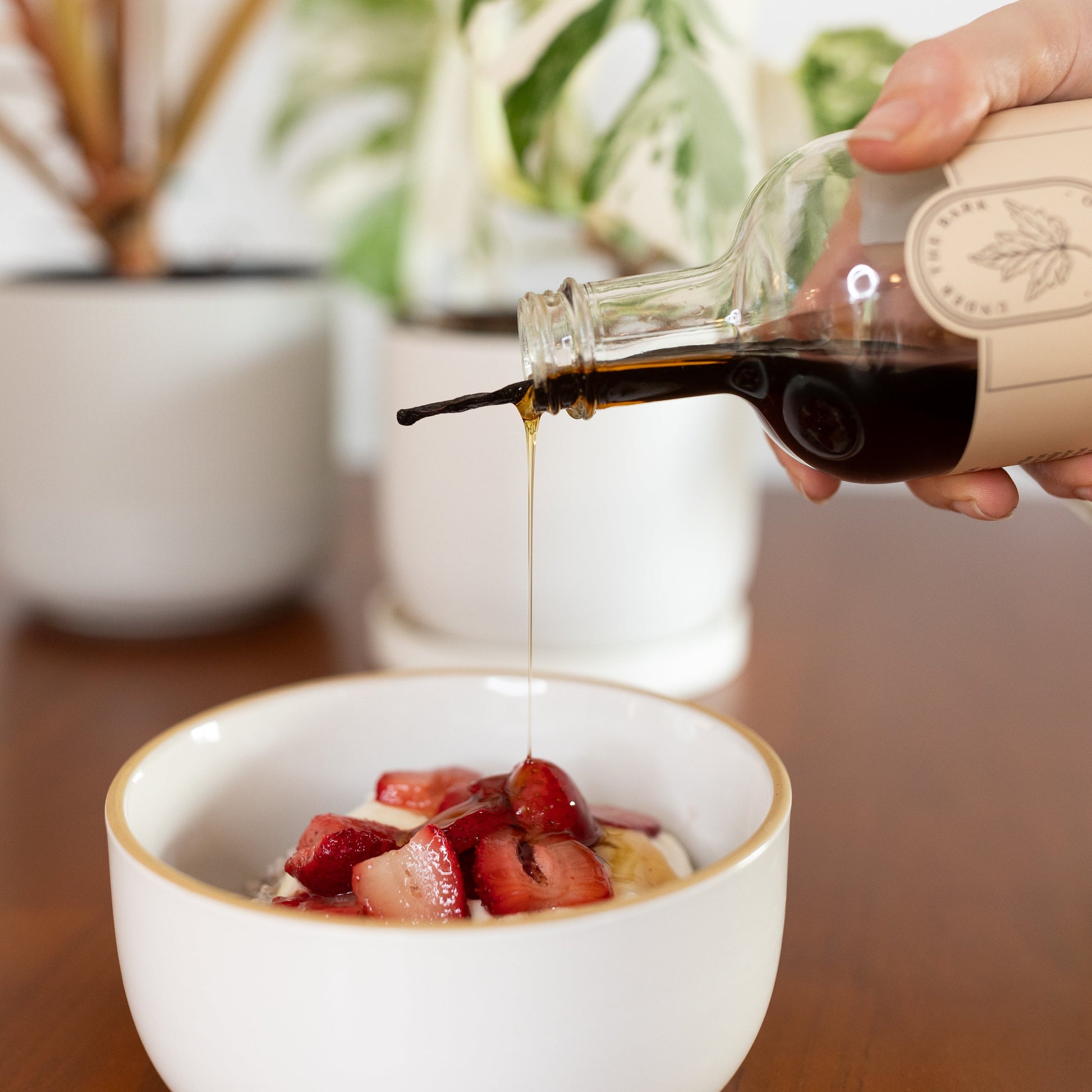 Strawberry vanilla chia pudding topped with vanilla maple syrup from Under The Bark Syrup Co, showcasing a delicious breakfast treat.