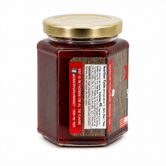 Jar of Strawberry Rhubarb Jam from Nutt Family Jams & Jellies, 9 oz, with fresh strawberries and rhubarb visible in the image.