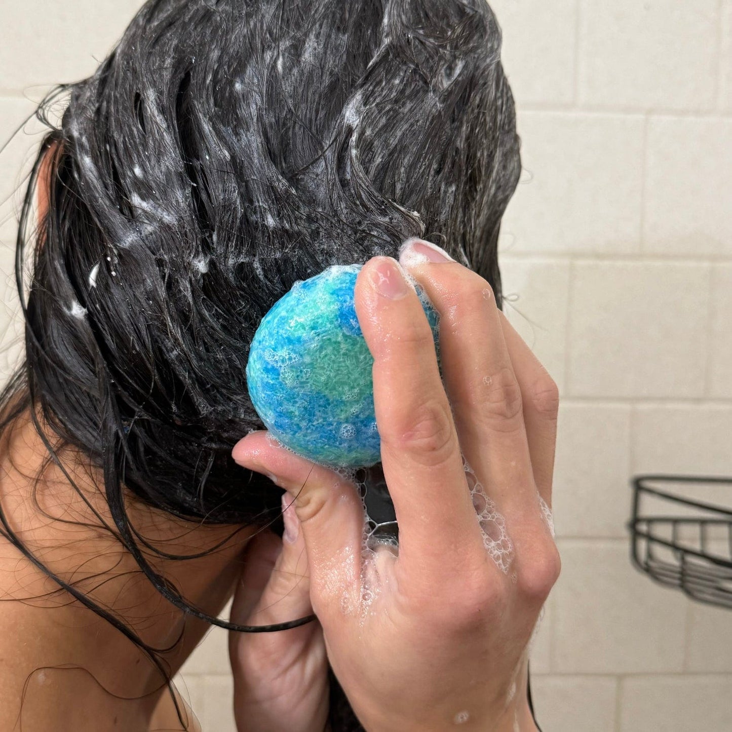 Eco-friendly shampoo bar with suds from ZeroWasteStore.com, showcasing a natural, plastic-free hair cleansing product.