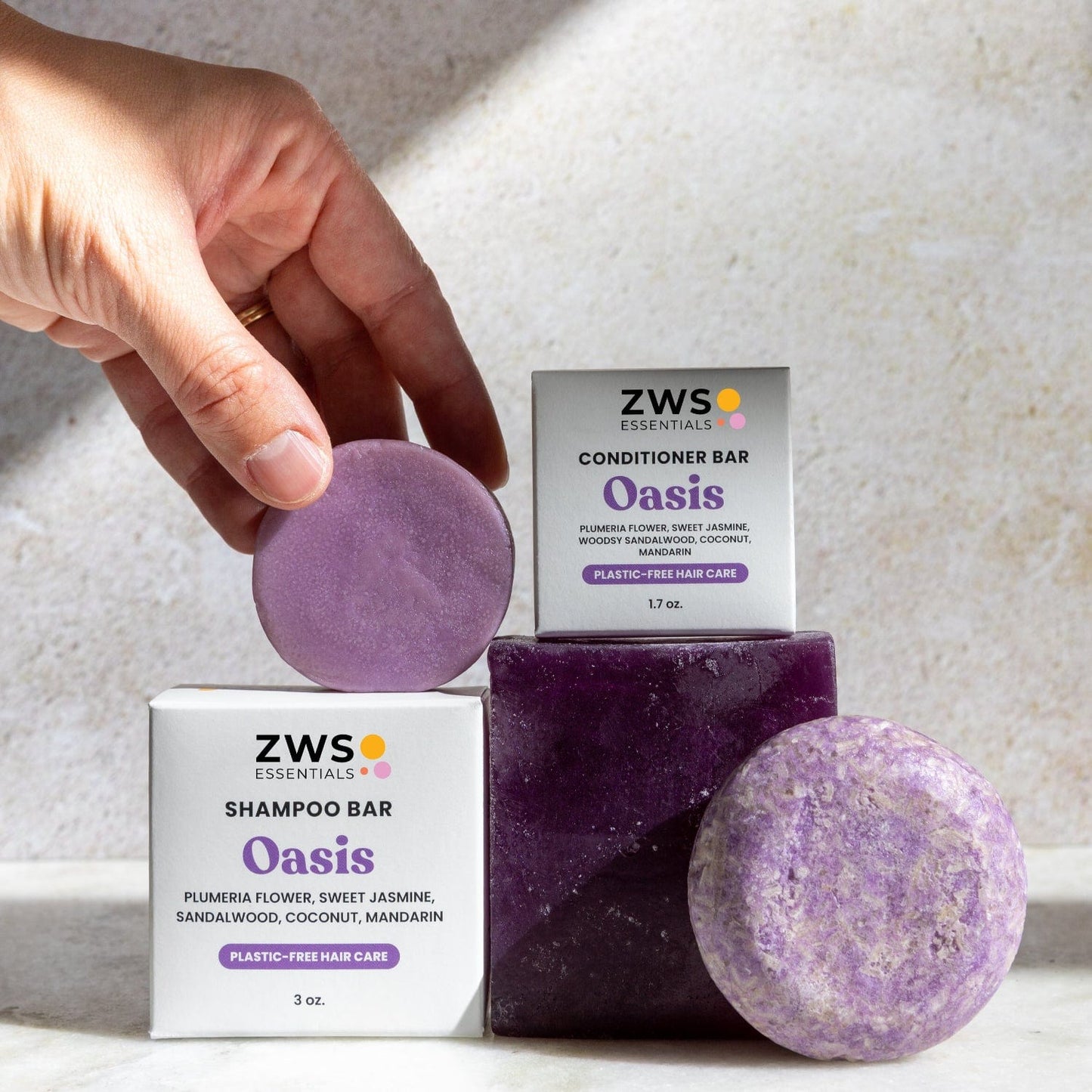 Eco-friendly shampoo and conditioner bar duo from ZeroWasteStore.com, with natural ingredients and soap suds on a wooden surface.