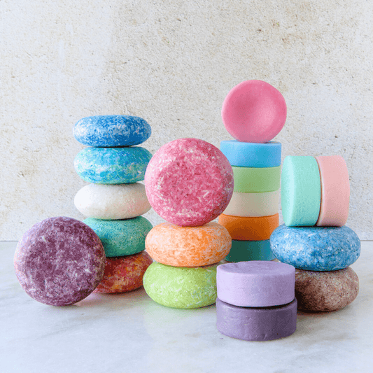 Eco-friendly shampoo and conditioner bar duo from ZeroWasteStore.com, featuring natural soap bars with suds and packaging.