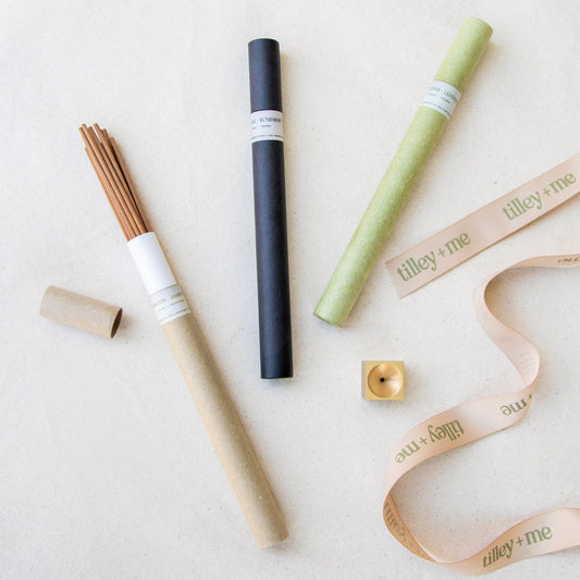 Set of Tilley + Me essential oil incense sticks with accessories for aromatherapy, displayed in a flat lay arrangement.