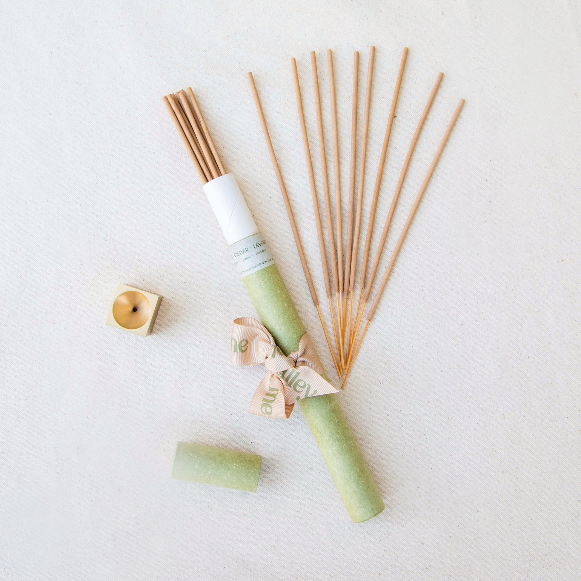 Set of Tilley + Me essential oil incense sticks for aromatherapy with accompanying accessories, shown lying flat.