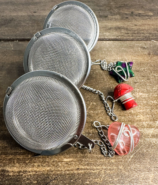 Herbalroseapothecary tea ball infuser with stainless steel mesh for loose leaf tea brewing, hanging loop for easy use.