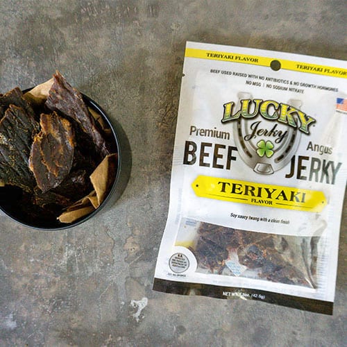 Thin slices of Teriyaki Beef Jerky from Nebraska Star Beef in a 1.5 oz package, showcasing the savory glazed beef snack.