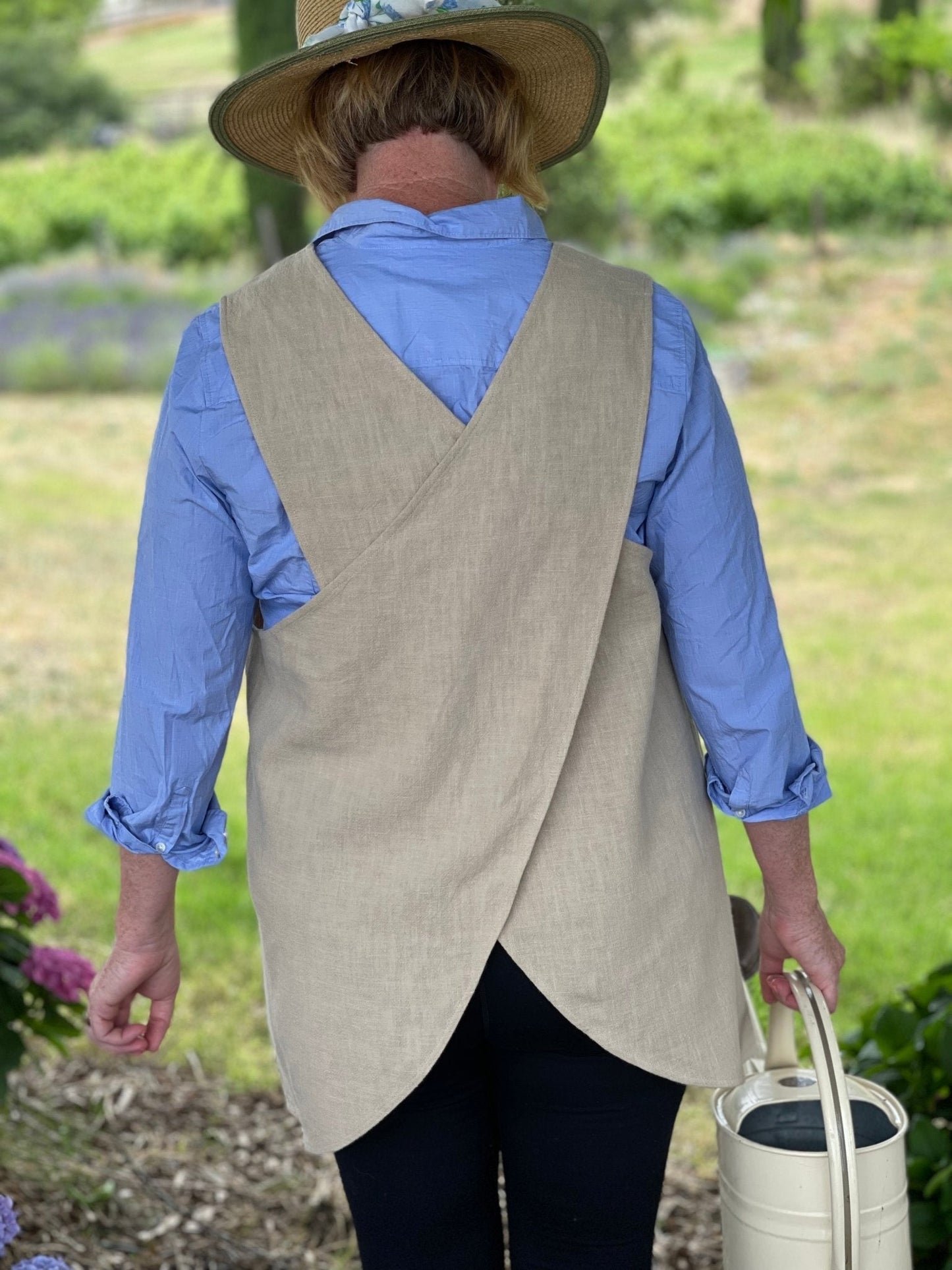 Sand linen apron with French-style crossback from The Celtic Farm, featuring a rustic, durable design for kitchen or craft use.