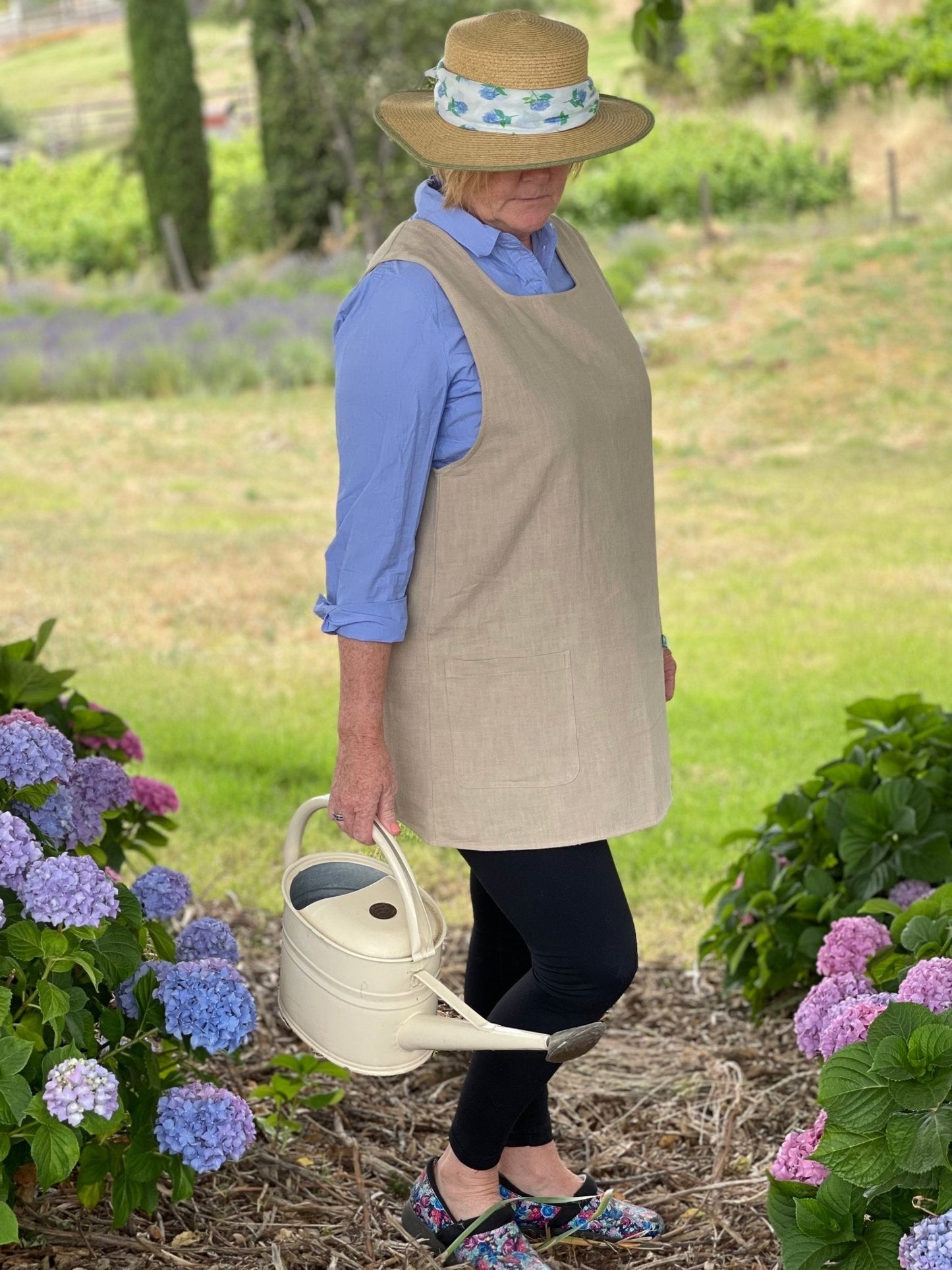 French-style crossback linen apron by The Celtic Farm, featuring a sand-colored, durable fabric and functional design.