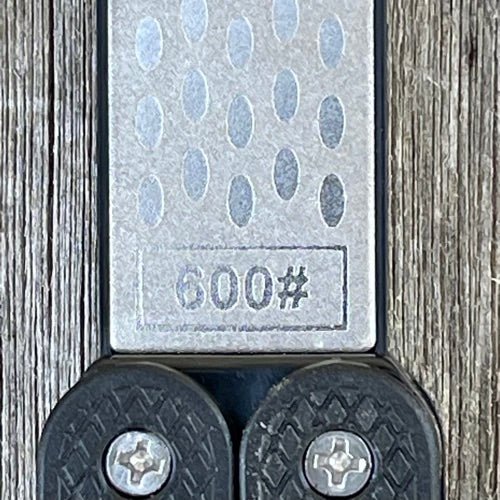 The Celtic Farm garden tool sharpener for clippers and pruners, featuring a reversible paddle with diamond and carbon steel honing surfaces.