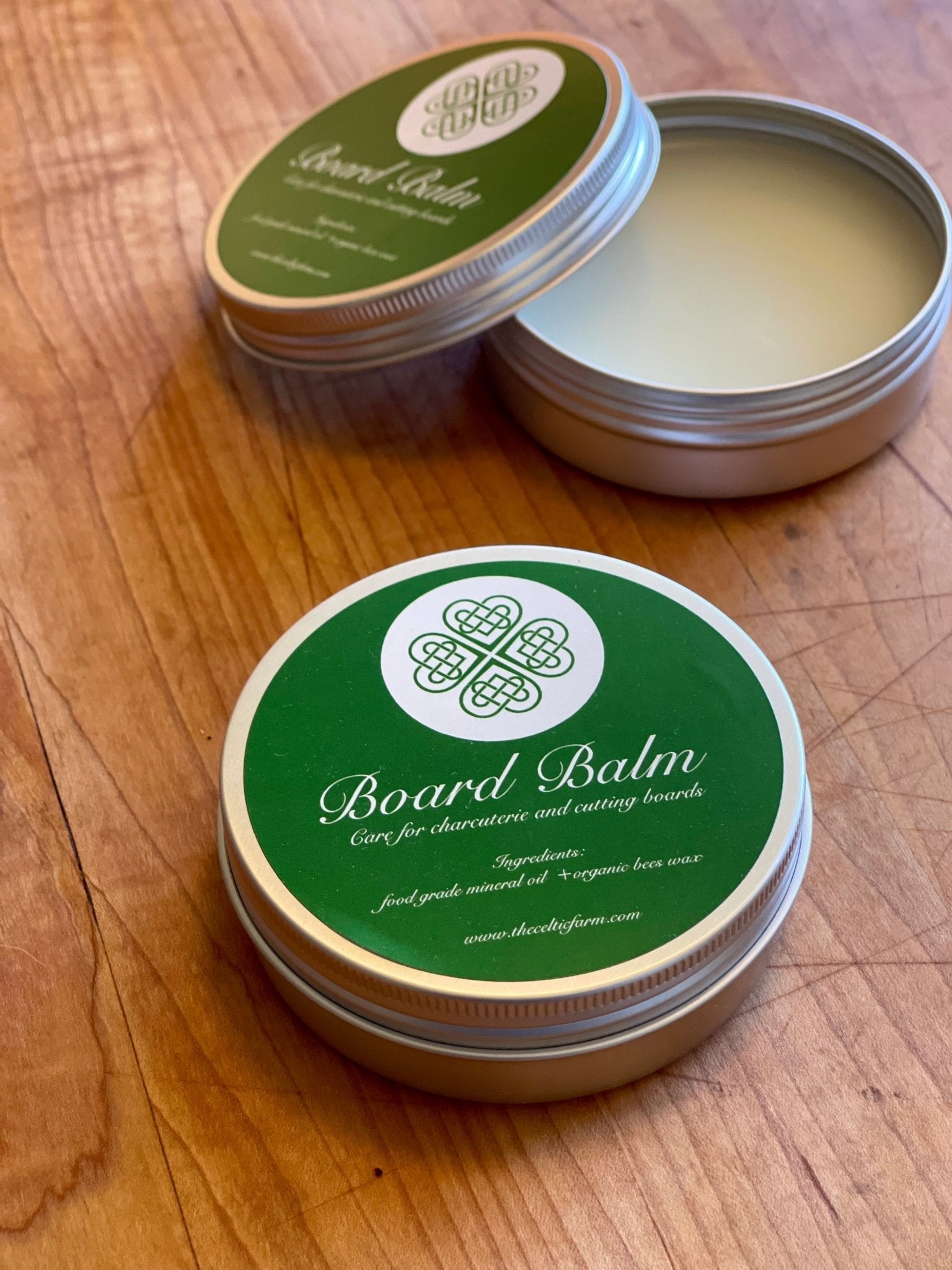 The Celtic Farm Board Balm shows a jar of oil and wax for treating cutting and charcuterie boards, highlighting natural wood protection.