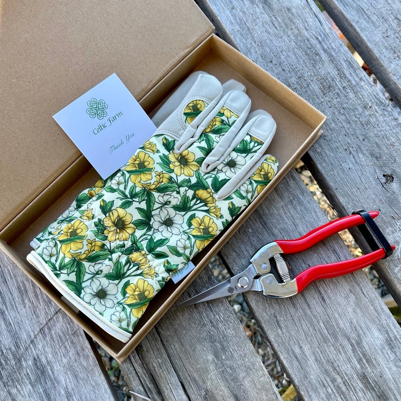Garden Gift Box from The Celtic Farm with green and yellow gardening gloves and needle snips for gardening tasks.