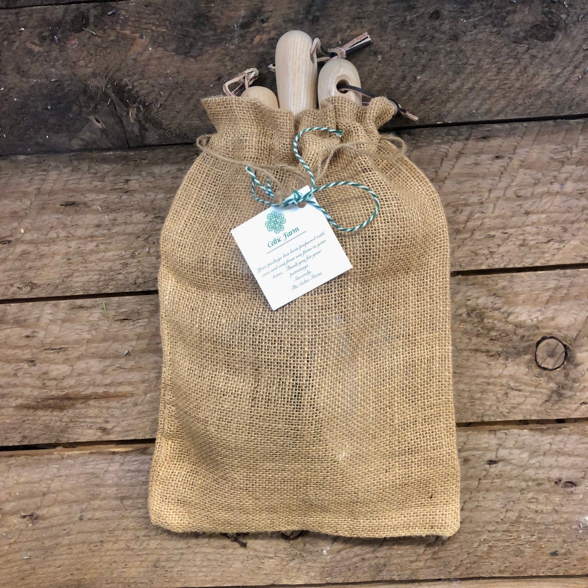 The Celtic Farm garden gift box with burlap bag containing planting efficiency tool set, bulbs, and seeds for gardening.