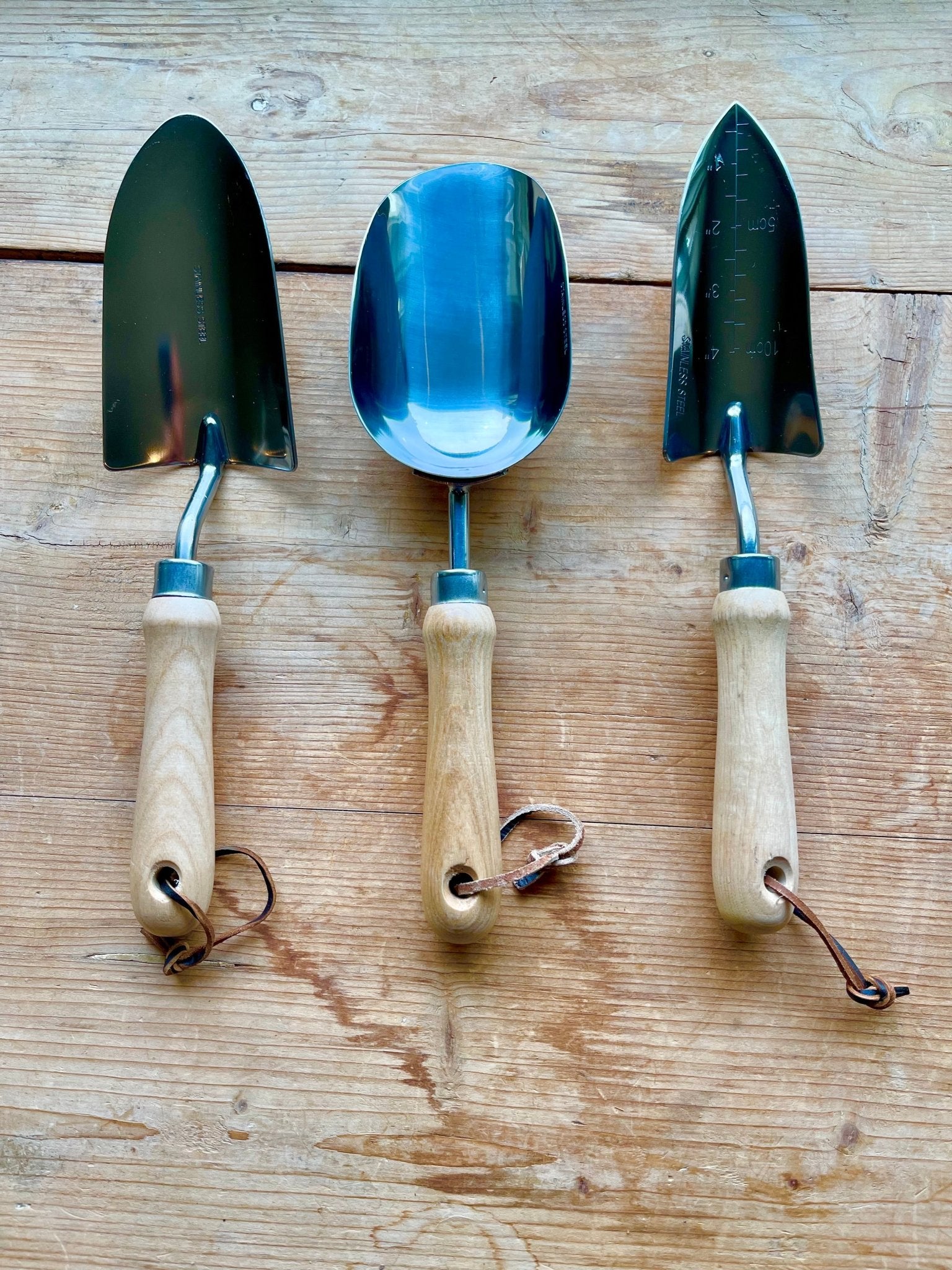 The Celtic Farm Potter's Tool Set with three gardening tools inside a burlap gift box, perfect for potting and gardening projects.