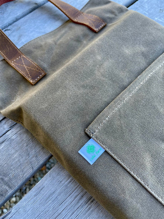 Waxed canvas garden kneeler pad by The Celtic Farm, providing comfortable support for gardening tasks and kneeling.