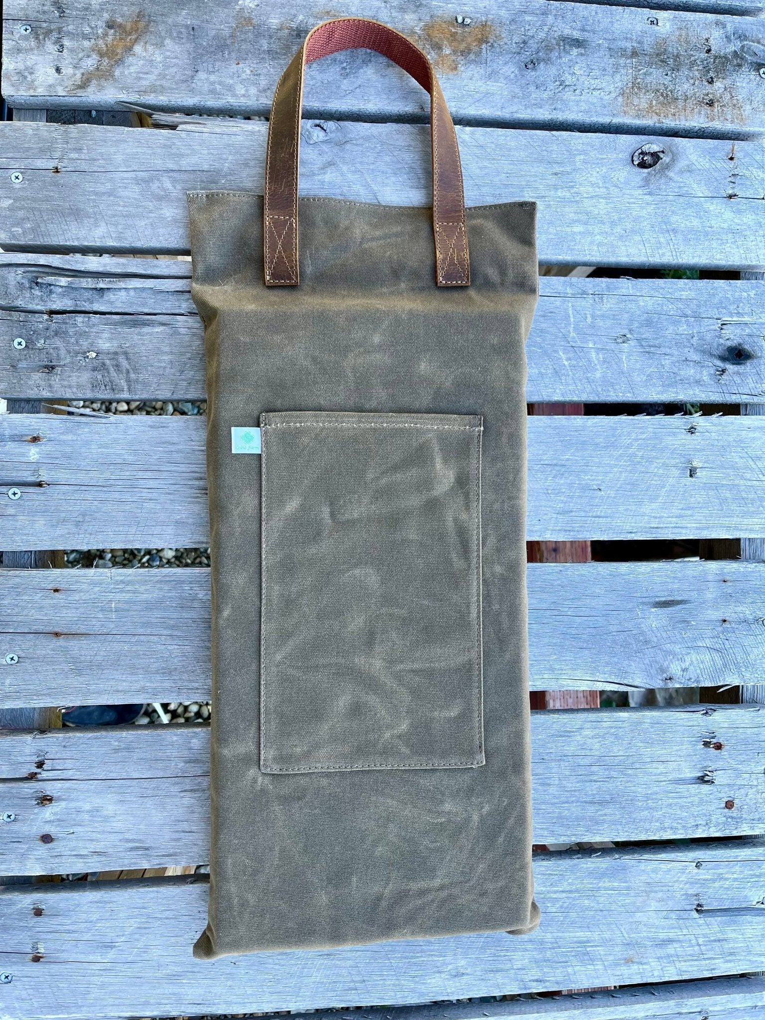 Waxed canvas garden kneeler pad by The Celtic Farm, providing comfortable cushioning for gardening tasks.