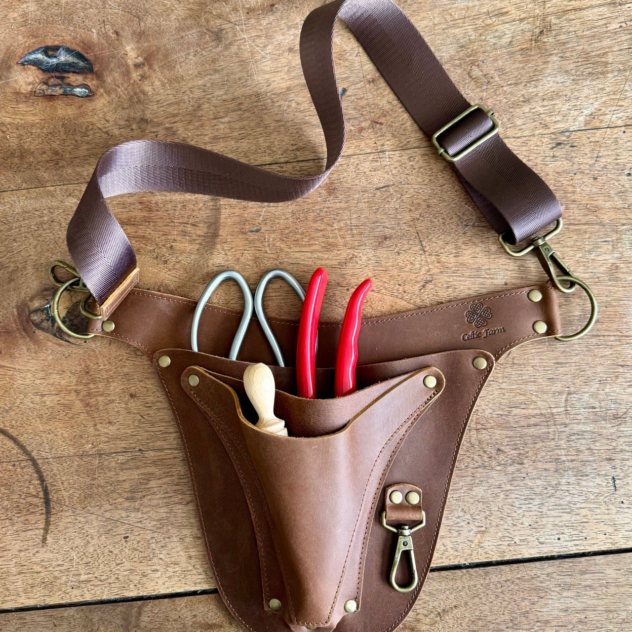 Leather garden tool belt by The Celtic Farm with extra rivets, designed for master gardeners, featuring multiple tool holders.