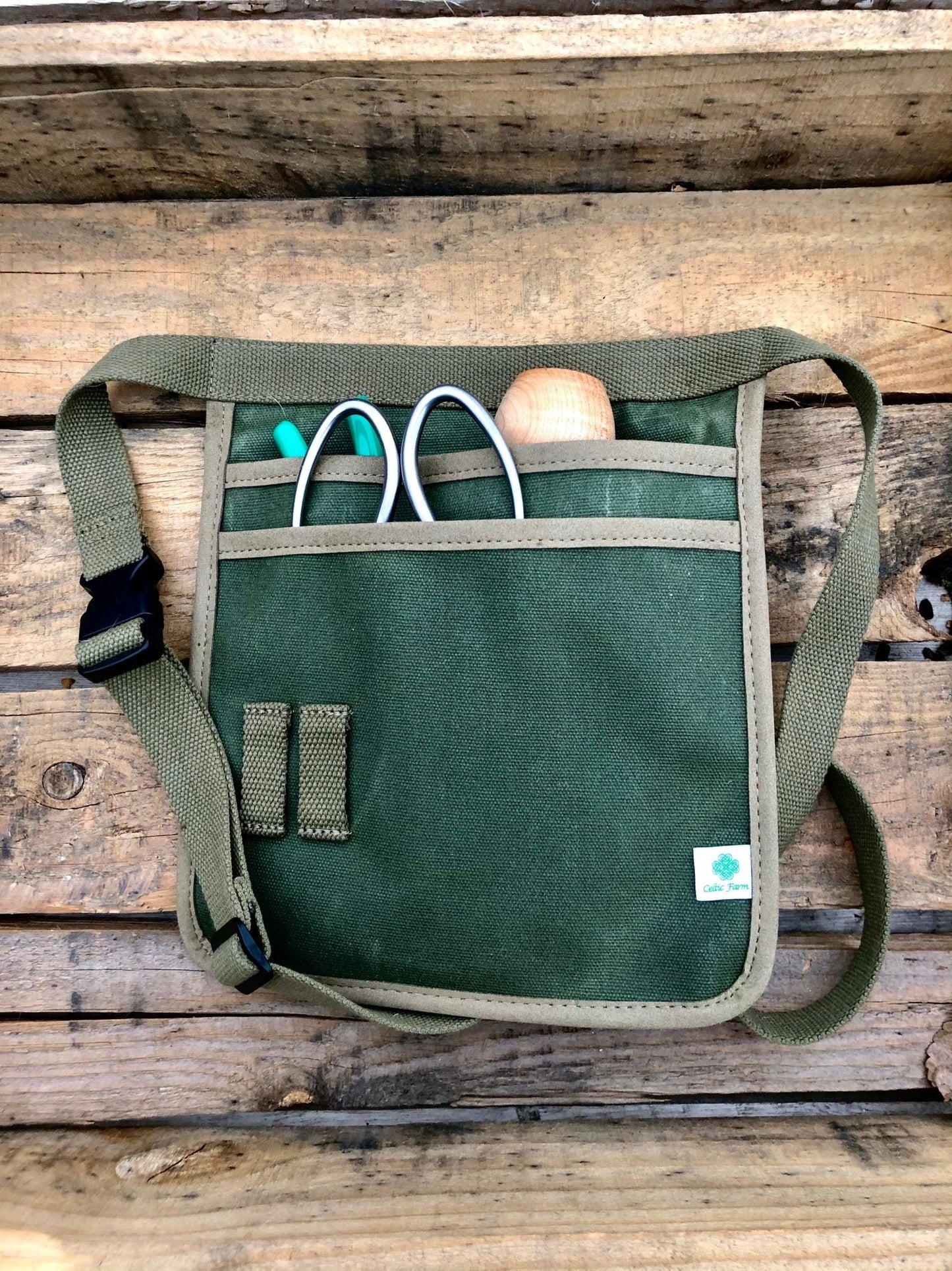 Celtic Farm waxed canvas garden tool belt in hunter green with multiple pockets for gardening tools and accessories.