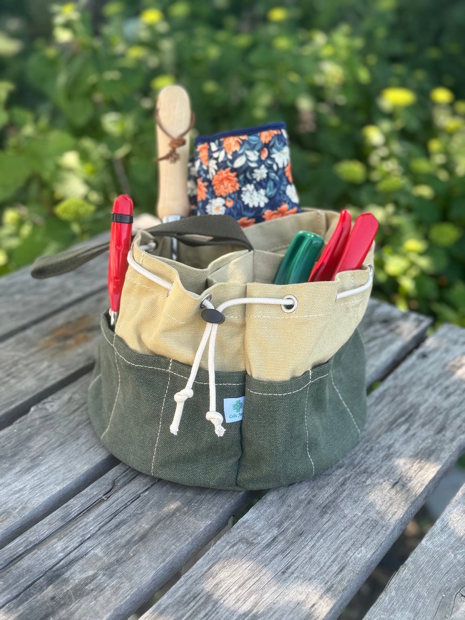 Heavy waxed canvas garden bucket bag by The Celtic Farm, durable gardening tote with spacious interior and sturdy handle for outdoor use.