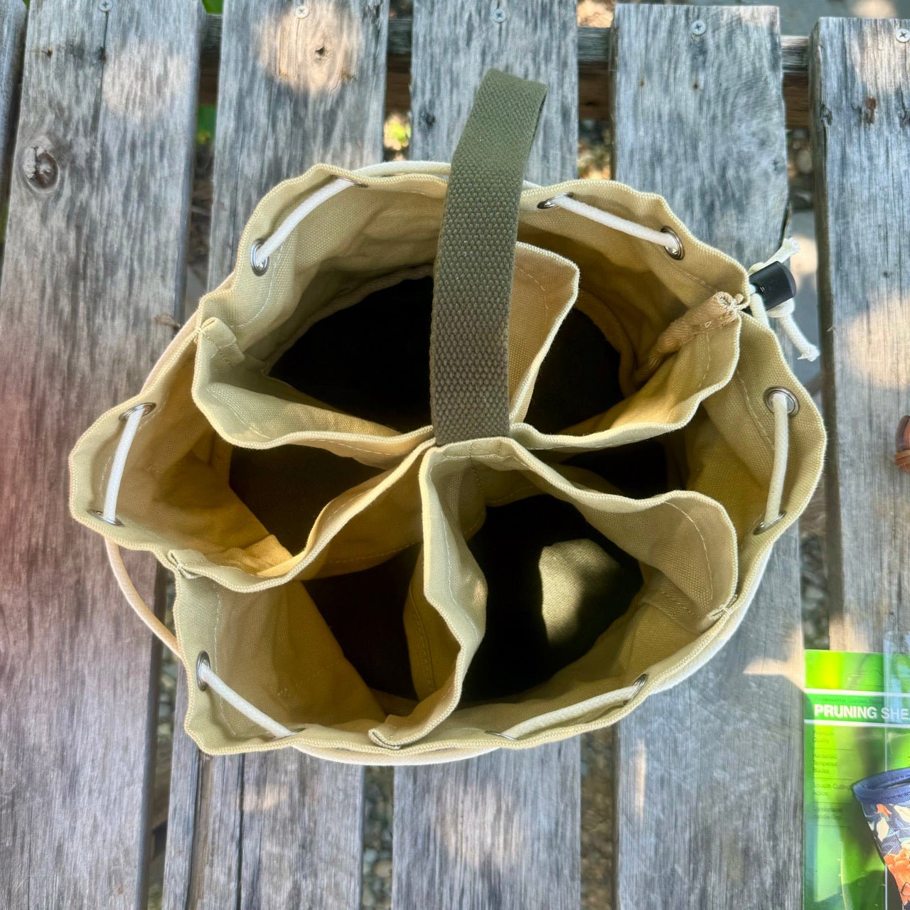 Heavy waxed canvas gardening tote bag from The Celtic Farm, designed as a durable garden bucket bag for outdoor tools.