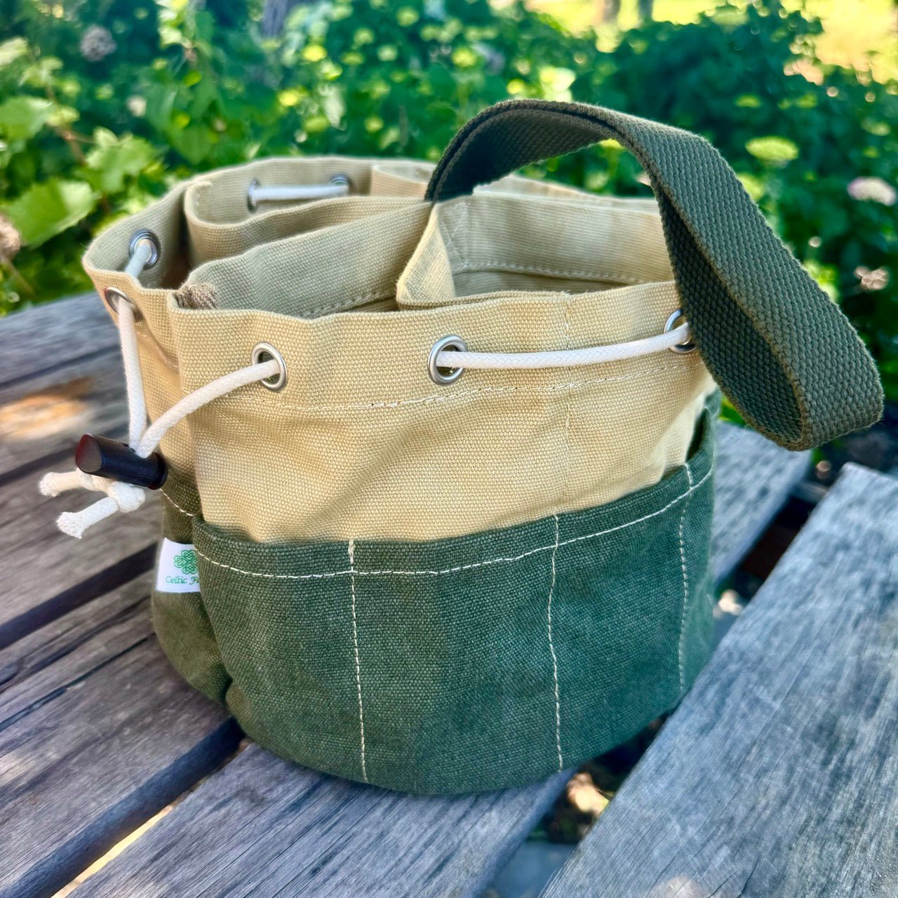 Heavy waxed canvas garden bucket bag from The Celtic Farm, durable gardening tote with multiple compartments for tools.