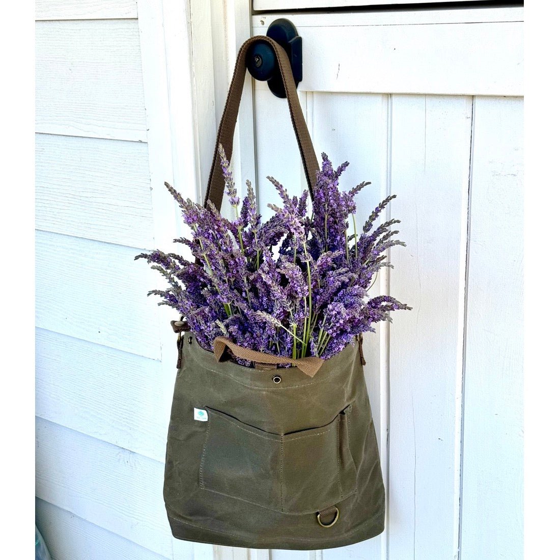 The Celtic Farm gardener's multipurpose shoulder bag with multiple compartments for tools, market items, or harvest.