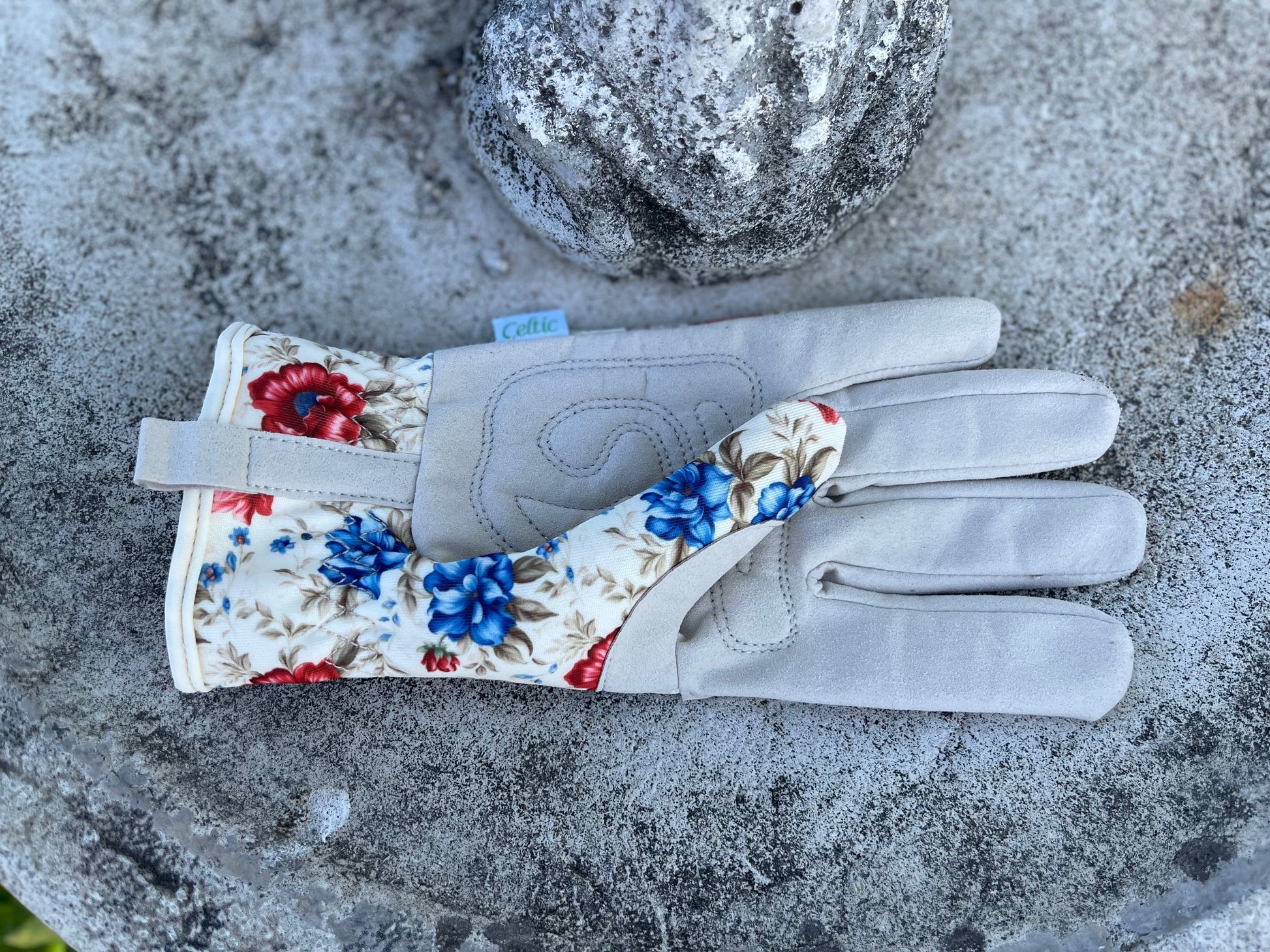 Women's floral gardening gloves "The Caroline" by The Celtic Farm, showing colorful fabric with floral pattern and reinforced fingertips.