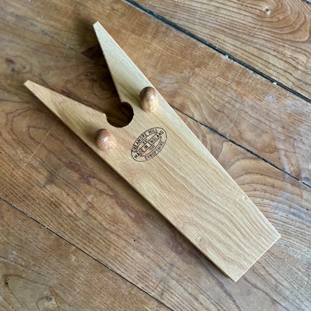 White oak English boot jack from The Celtic Farm, a sturdy home accessory for removing boots easily.