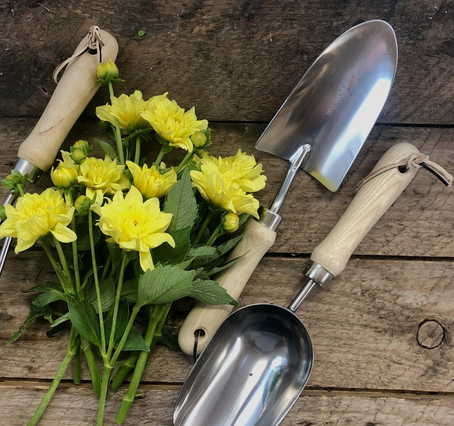 Garden hand tool set by The Celtic Farm with hardwood handles and stainless steel tools, displayed in a burlap bag.