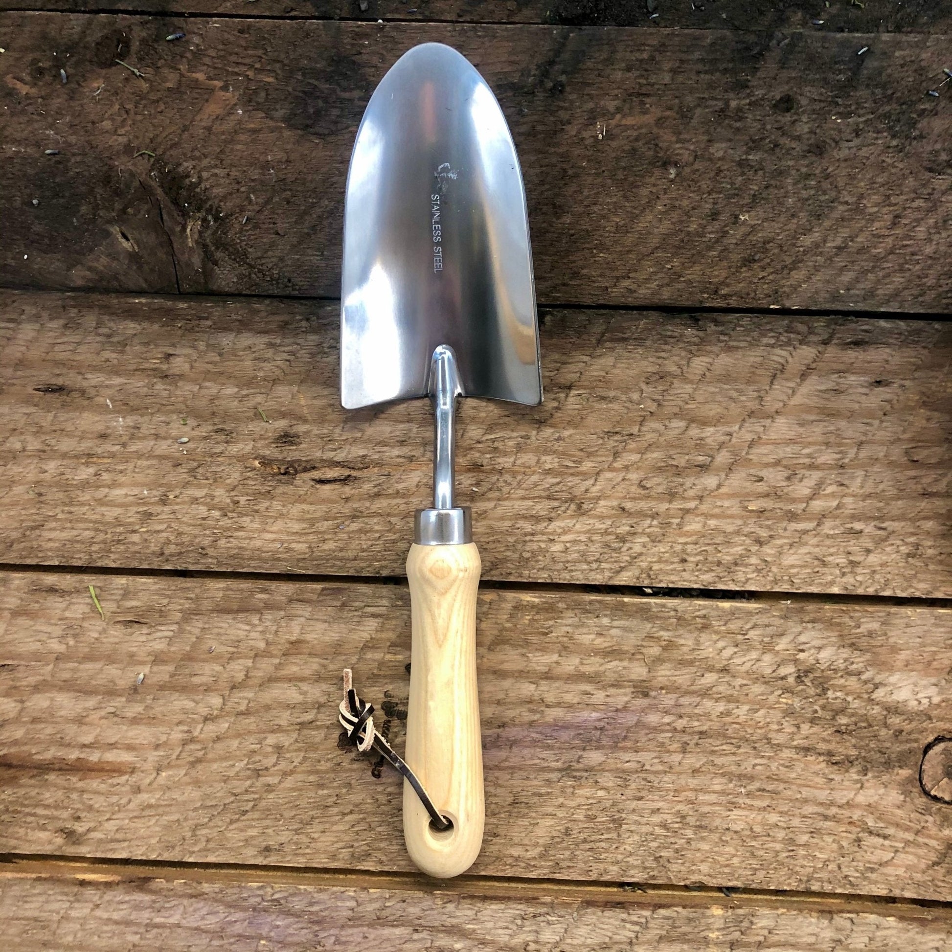The Celtic Farm garden hand tool set with hardwood handles and stainless steel tools inside a burlap bag.