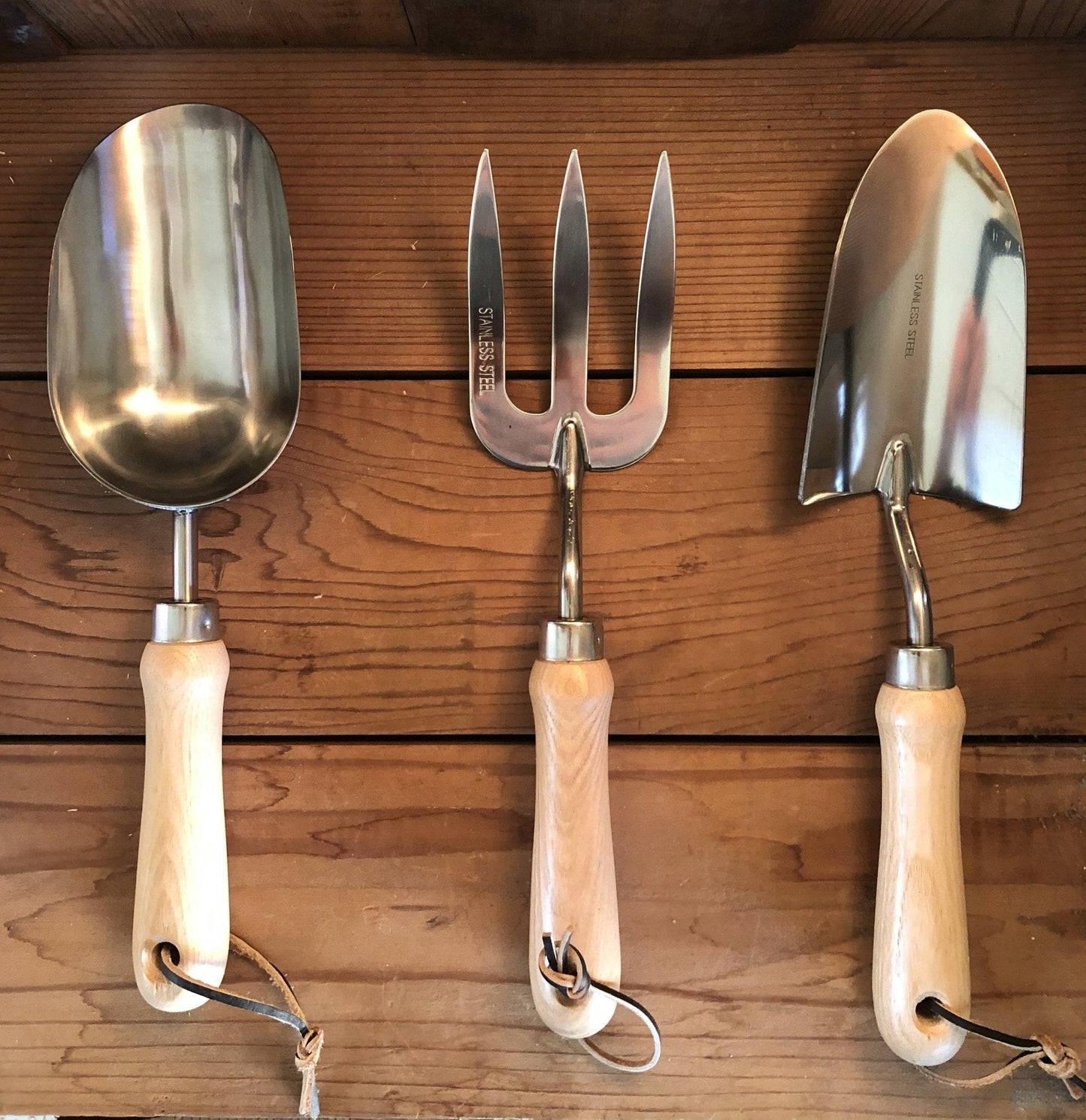 Garden hand tool set by The Celtic Farm with hardwood handles and stainless steel tools in a burlap bag.