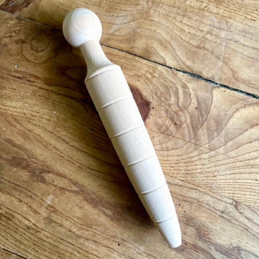 Garden dibber tool by The Celtic Farm for planting seeds, imported from Britain, with a wooden handle and pointed tip.