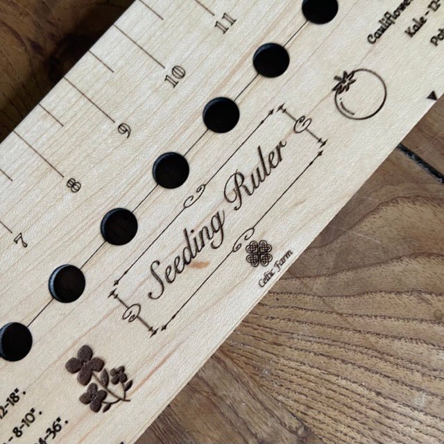 The Celtic Farm garden gift set with American hardwood seed and bed ruler, dibblers, pot tamper, and markers arranged on a wooden surface.
