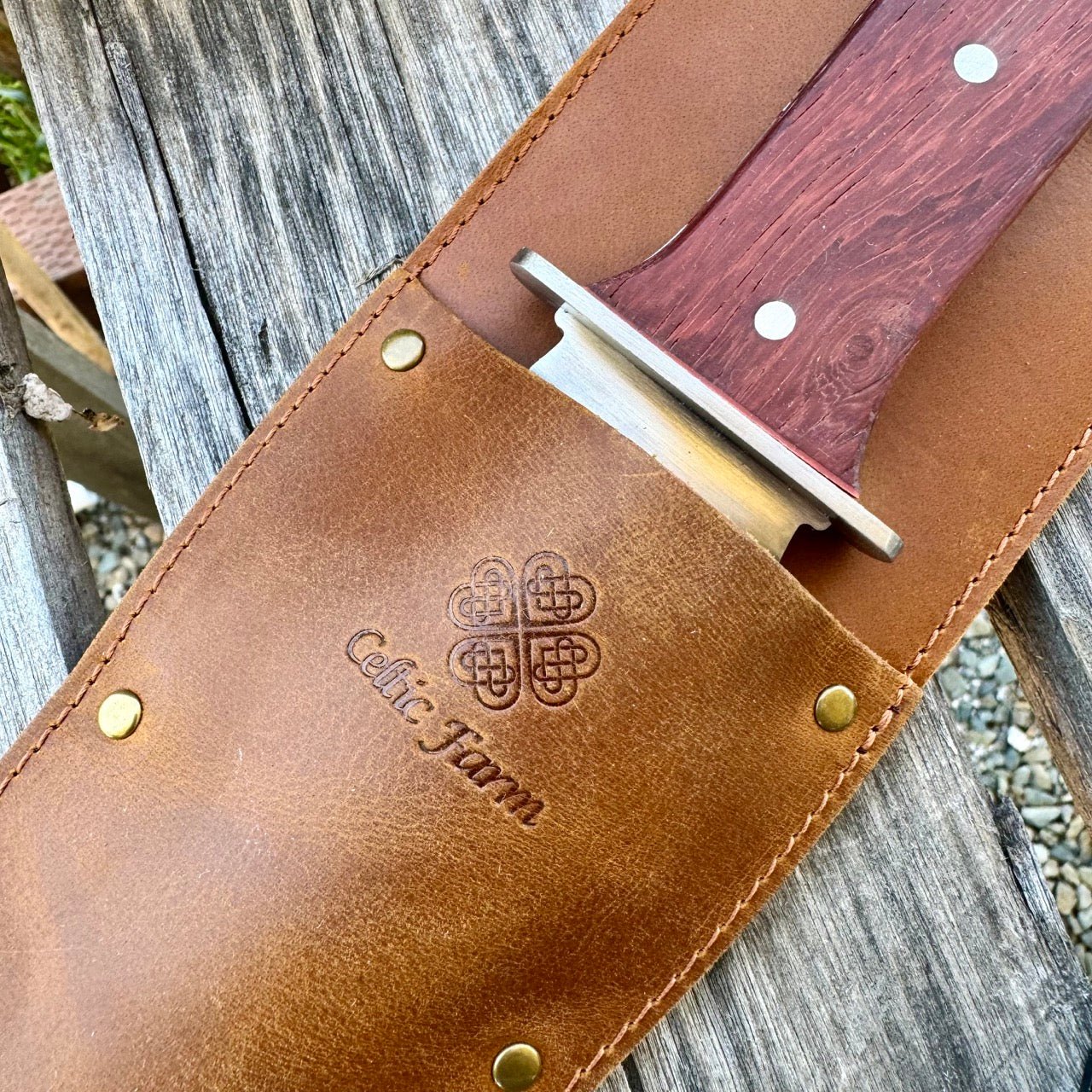 The Celtic Farm Hori Hori garden tool in a gift box, featuring a versatile gardening knife with a wooden handle and stainless steel blade.