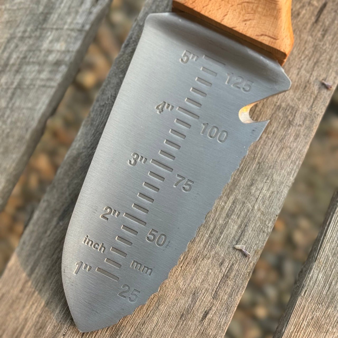 Celtic Farm Tanto Hori Hori garden tool with a sharp blade and wooden handle, ideal for gardening and planting tasks.