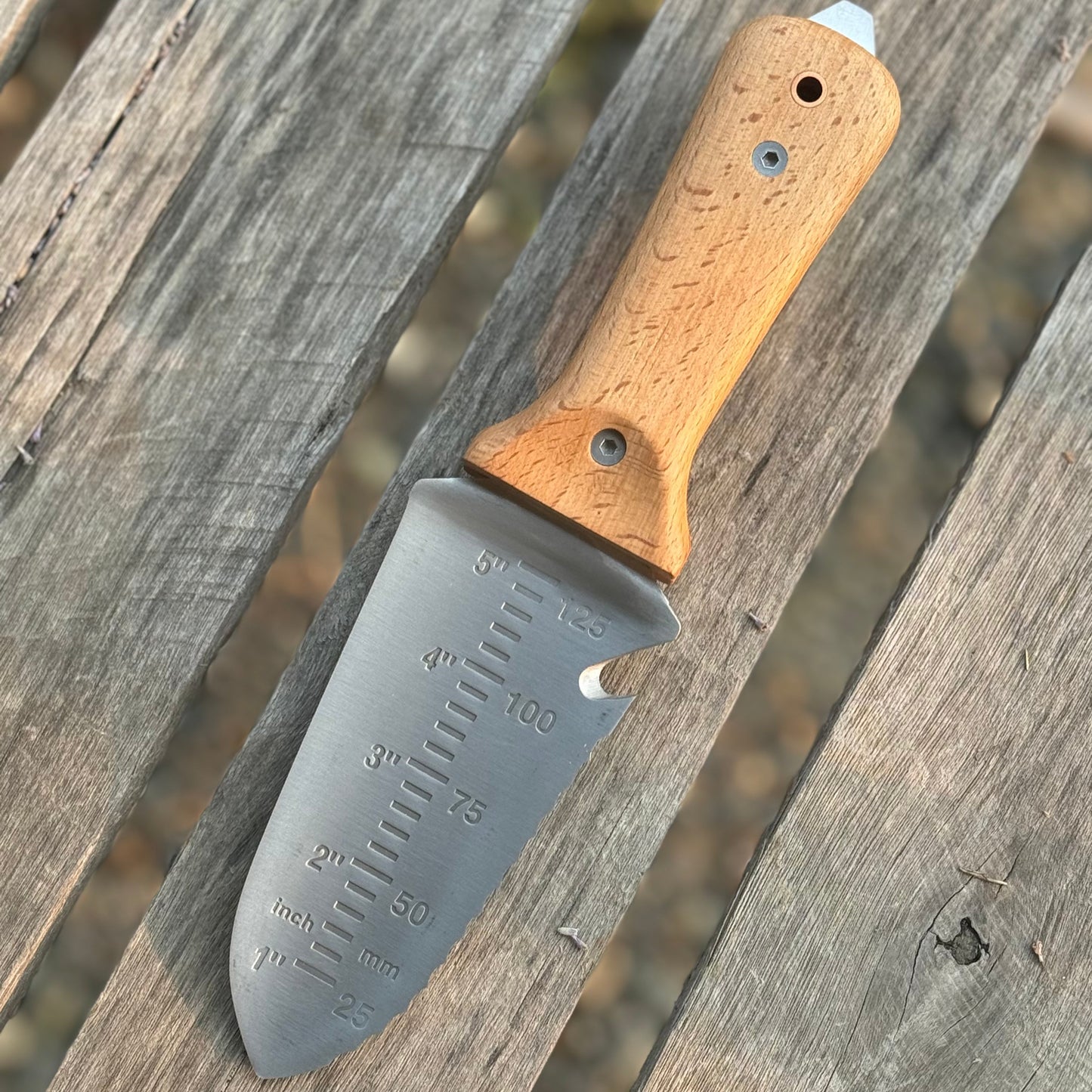 Celtic Farm Tanto Hori Hori garden tool with wooden handle and sharp blade for digging and planting in the garden.