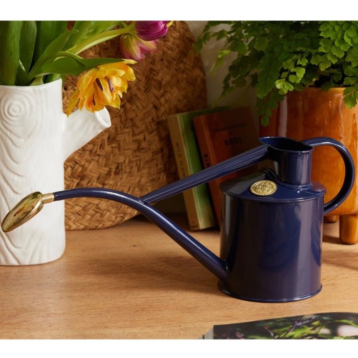 Dark green Haws Rowley Ripple watering can by The Celtic Farm, with a curved handle and ribbed design for easy watering.